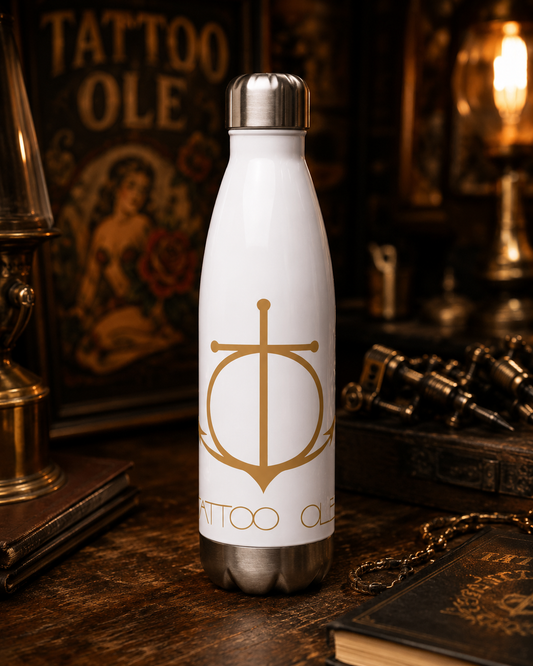 Tattoo Ole stainless steel water bottle with gold anchor logo inside the Copenhagen tattoo studio