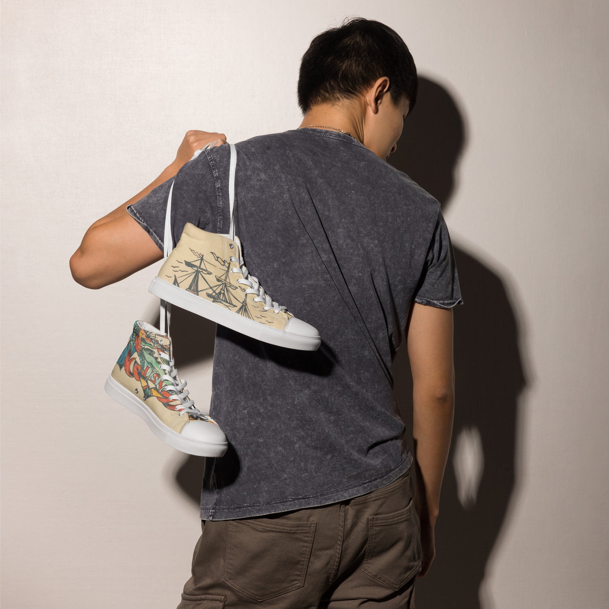 Men’s high top canvas shoes with cool ship design by Tattoo Ole model shoulder